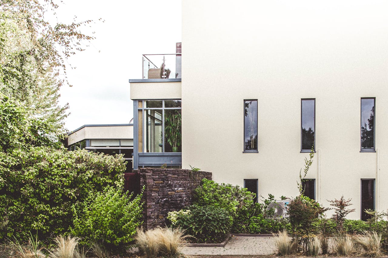 Elegant modern home exterior surrounded by lush greenery in Cork, Ireland.